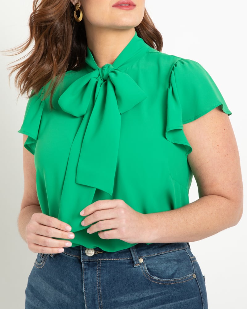 Front of a model wearing a size 14 Willow Flutter Sleeve Blouse in Jelly Bean by ELOQUII. | dia_product_style_image_id:206799